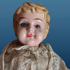 Unusual metal head antique doll